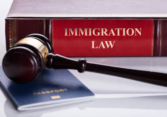 Close-up Of Gavel And Passport In Front Of Law Book